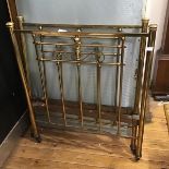 An Edwardian single brass bed, with vertical brass spars complete with base and rails, on original