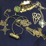 A mixed lot of white metal and metal Eastern jewellery including brooches, pendants, chains, jade