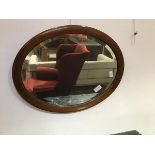 An early 20thc. mahogany framed mirror with satinwood inlay and bevelled glass plate (69cm x 53cm)