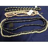 A collection of cultured pearls necklaces, including a long strand of black/silver pearls, green
