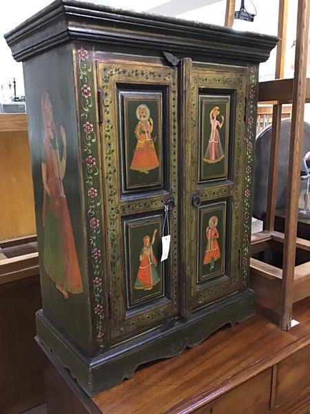 An Indian painted cupboard, the plain top above a pair of inset panel doors , each decorated with