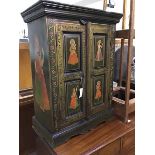 An Indian painted cupboard, the plain top above a pair of inset panel doors , each decorated with