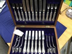 An oak cased silver plated dessert set of twelve knives, six forks and six spoons, Elkingon & Co.,