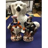 A 19thc Staffordshire chimney Spaniel and a pair of Highland Staffordshire figures decorated with