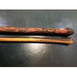 An early 20thc carved Japanese walking cane, with root knot pommel, with a carved entwined snake and