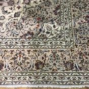 A hand knotted Iranian carpet, the central rectangle with allover scrolling lotus flower and leaf