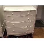 A Georgian style white painted bow front chest of drawers, the top with moulded edge above two short