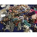 A mixed lot of mainly hardstone pebble and bead necklaces together with miscellaneous bangles