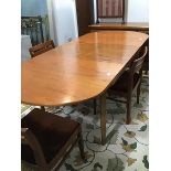 A Nathan Furniture 1970's teak dining table, the pull out top with curved ends enclosing a magic