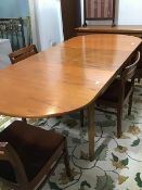 A Nathan Furniture 1970's teak dining table, the pull out top with curved ends enclosing a magic