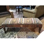 A kelim upholstered fender footstool, on hardwood turned legs (44cm x 113cm x 43cm)