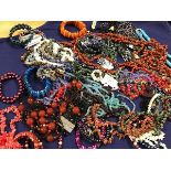 A mixed lot of beads, bangles and pendants, many set hardstone, polished pebble etc. (a lot)