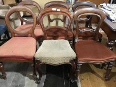 A harlequin set of six Victorian balloon back dining chairs, composed of a set of three chairs, a