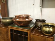 A mixed lot of copper and brass including an early 20thc hammered copper cooking pot with rounded