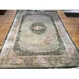 A Chinese cotton and washed wool carpet, the shaped panel with central medallion, with lotus
