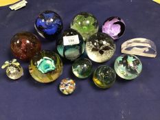 A collection of glass paperweights including six Caithness paperweights (tallest: 10cm) together