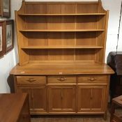 A modern elm Ercol Cotswald style dresser, the raised plate rack above three drawers and three