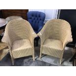 A pair of Lloyd Loom cream painted verandah armchairs, paper label to interior (each: 82cm x 69cm)