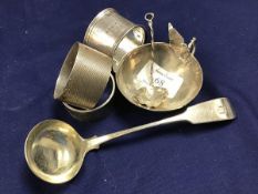 A mixed lot of silver including three hallmarked napkin rings, a small sauce bowl and matching spoon