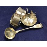 A mixed lot of silver including three hallmarked napkin rings, a small sauce bowl and matching spoon