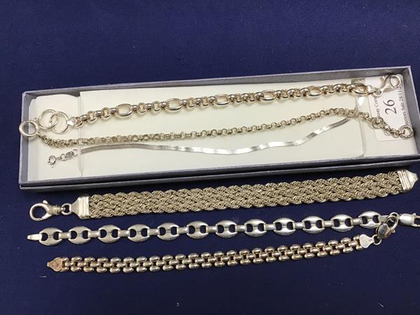 A group of white metal bracelets and chains, including a three strand rope fancy link bracelet (