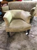 A Victorian upholstered low back horseshoe shaped tub chair, on turned supports with later castors