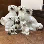 A collection of 7 19thc Staffordshire chimney spaniels decorated with polychrome enamels. (