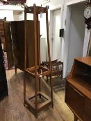 A 1920's oak hat and coat stand, of squarer tapered form, the top with bronzed hooks, with