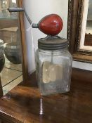 A British made butter churn with hand driven mechanism to top, with steel lid, wooden churn on glass