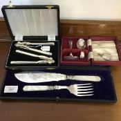 A cased set of carved mother of pearl handled fish servers with silver bands, in velvet fitted case,