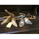A mixed lot comprising two pairs of wooden shoe trees and four walking sticks