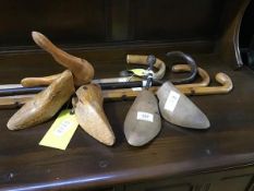 A mixed lot comprising two pairs of wooden shoe trees and four walking sticks