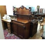 A Victorian chiffonier, the carved back with open shelf raised on turned supports, the rectangular