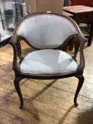 An Edwardian upholstered walnut frame armchair, with sweeping top rail, upholstered back and seat,