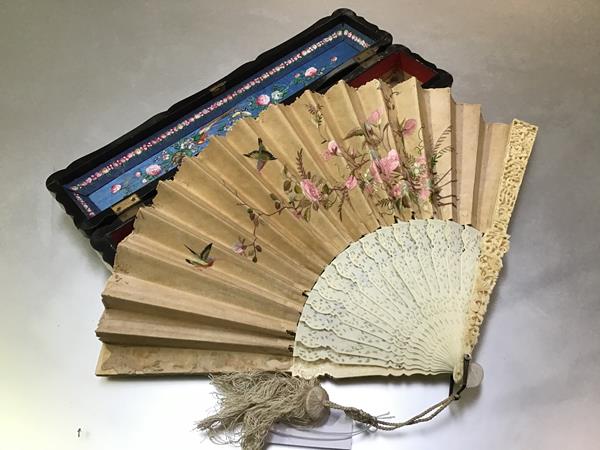 A Canton Chinese carved ivory and silk fan, c. 1900, the guards elaborately carved in relief with