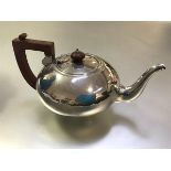 A George V silver teapot, maker's mark TJ, Birmingham 1932, of compressed spherical form, with