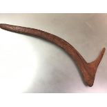 An Aboriginal spurred boomerang, Australia, with planished finish (repaired). 74cm