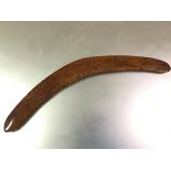 An Aboriginal boomerang, Australia, the indigenous wood with striking grain, gilt-lettered "E.