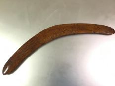 An Aboriginal boomerang, Australia, the indigenous wood with striking grain, gilt-lettered "E.