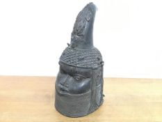 A Benin bronze head of an Oba, modelled with rhino horn headdress and high collar. 36cm