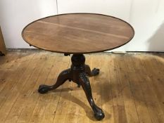 A 19th century mahogany tripod table, the circular dished top raised on a turned baluster-shaped