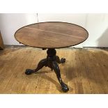 A 19th century mahogany tripod table, the circular dished top raised on a turned baluster-shaped