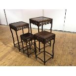 A quartetto set of Chinese hardwood tables, each with recessed top above a pierced foliate frieze,