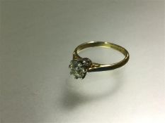 A single stone diamond ring, the round brilliant-cut stone weighing 0.65 carats, claw-set in