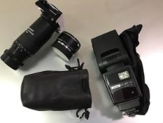 A Leica Extender-R 2x (lens extender), in a carry bag; together with a Metz 54 MZ-4i standard