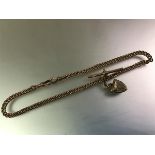 A 9ct gold curblink Albert, c. 1900, with a pair of lobster clasps, t-bar and a yellow metal heart-