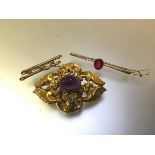 A group of three brooches comprising a Victorian yellow metal brooch (unmarked) centred by an oval