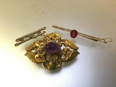 A group of three brooches comprising a Victorian yellow metal brooch (unmarked) centred by an oval
