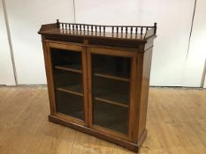 A Victorian walnut dwarf bookcase, the baluster gallery surmounted by ball finials, above a fluted