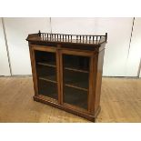 A Victorian walnut dwarf bookcase, the baluster gallery surmounted by ball finials, above a fluted